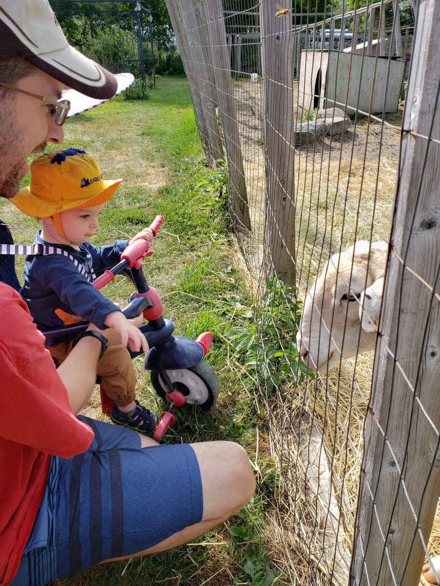 father and son with goat