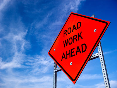 sign saying road work ahead